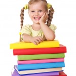 Little-girl-holding-pile-of-books